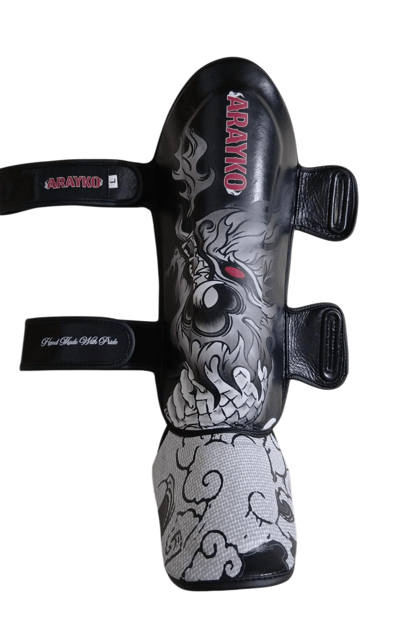 Premium leather shin pads by Arayko with traditional Thai Naga artwork and skull motif for boxing training