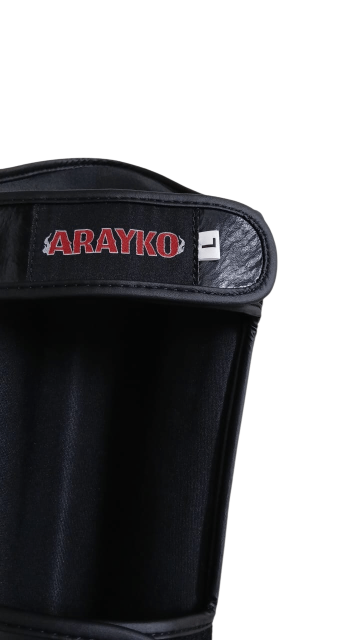 Black velcro strap with detailed red ARAYKO embroidered logo on leather shin guard