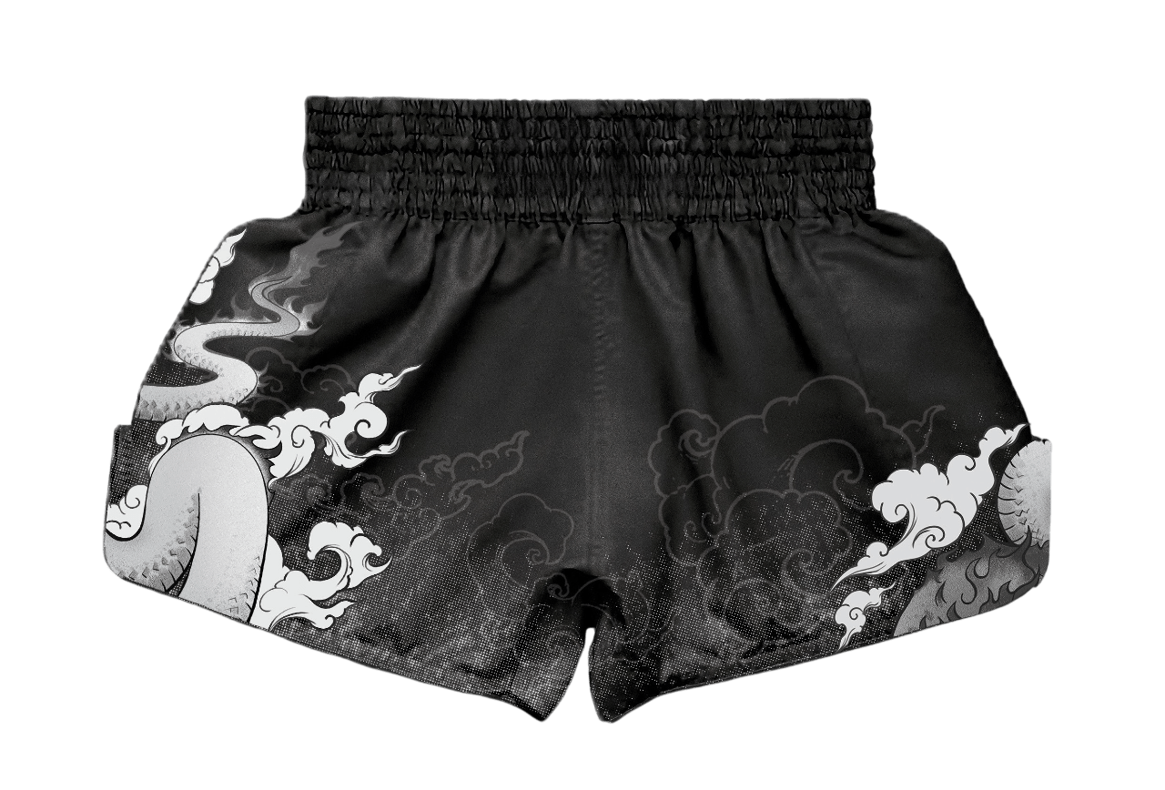 Rear view of custom Muay Thai shorts by ARAYKO. Features a continuous traditional dragon graphic across the back and sides with a reinforced gathered waistband for a secure training fit.