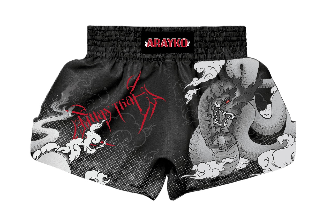 Custom black Muay Thai shorts with a large grey dragon and cloud design. The left side features bold red "Muay Thai" lettering in a stylized font, showcasing traditional combat sports apparel aesthetics.