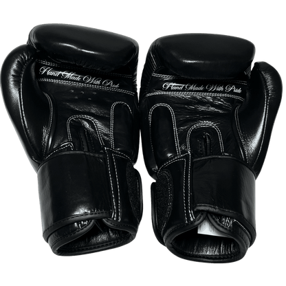 Handmade black boxing gloves in premium leather, designed for intense training and performance