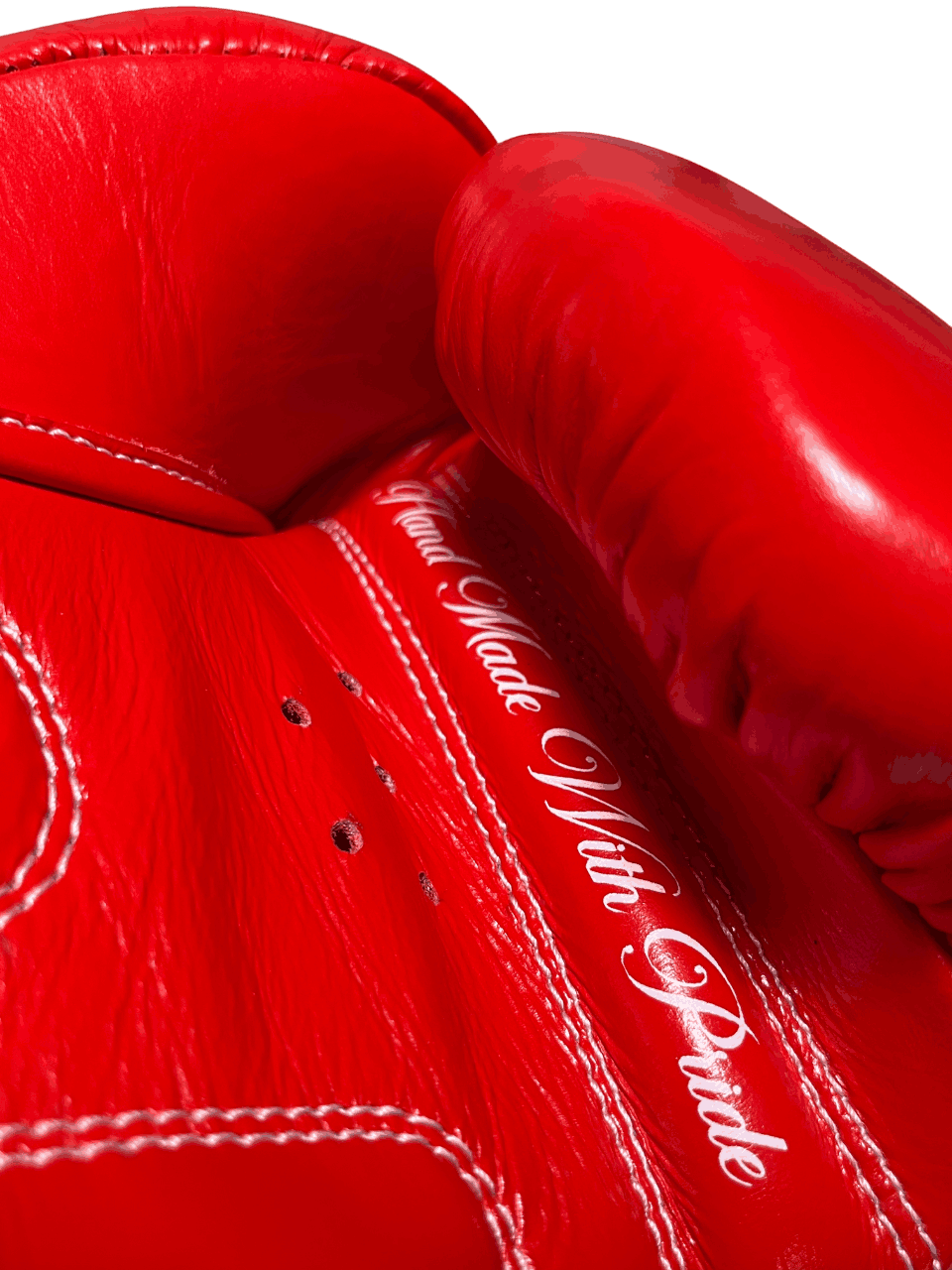 Palm side of Muay Thai glove showing cursive 'Hand Made With Pride' text, highlighting handcrafted quality and detail