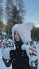 Woman in white furry hoodie with Arayko boxing gloves training in snowy mountain landscape