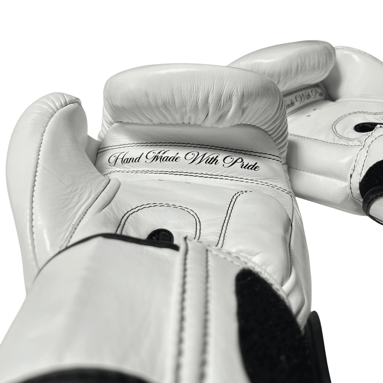 Handcrafted white Muay Thai gloves with black stitching, 'Hand Made With Pride' for top-tier performance