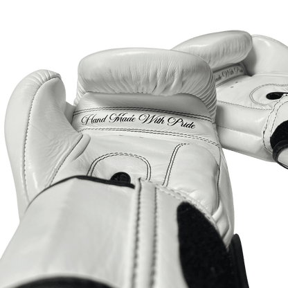 Handcrafted white Muay Thai gloves with black stitching, 'Hand Made With Pride' for top-tier performance
