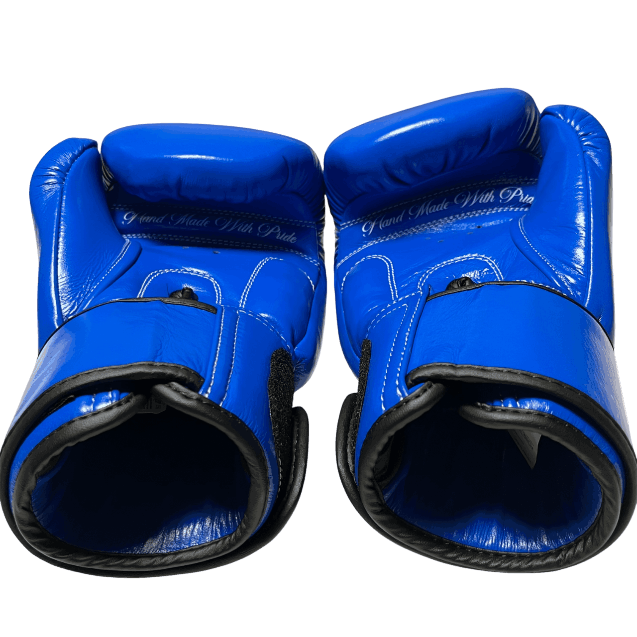 Pair of Royal Blue Muay Thai gloves with premium white stitching and 'Hand Made With Pride' text on the palm